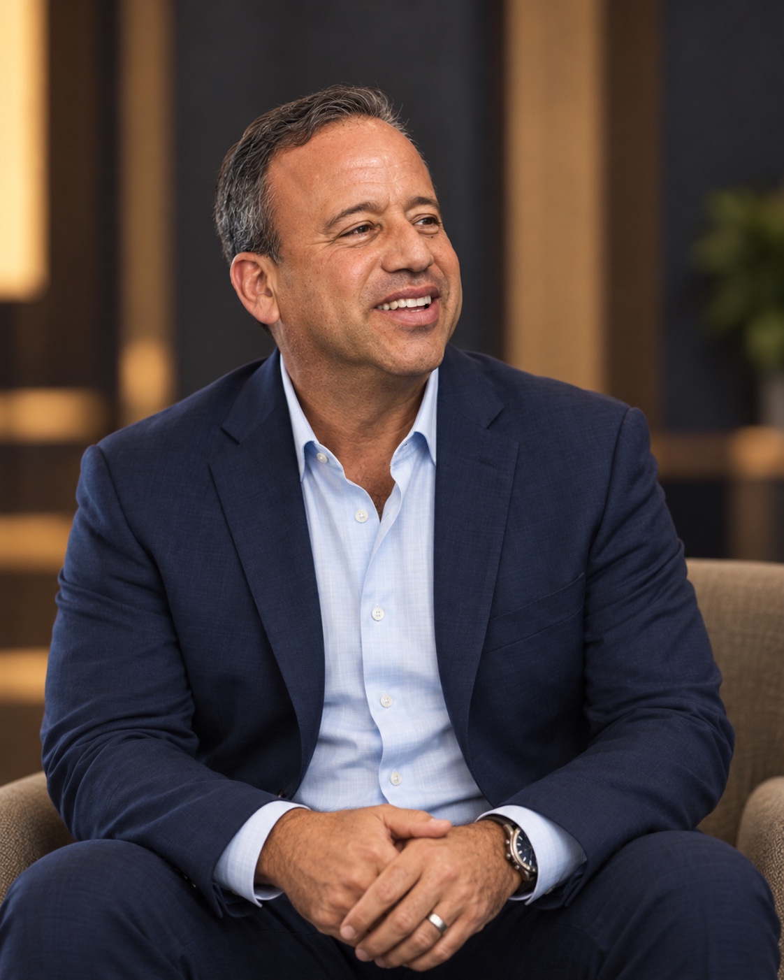 David Meltzer seated and smiling
